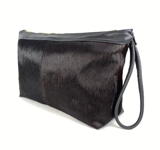 Large oversized cloth purse made from hair-on cowhide leather.