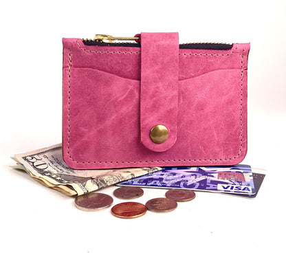 Barbie pink leather minimalist wallet with zippered pocket and card strap.