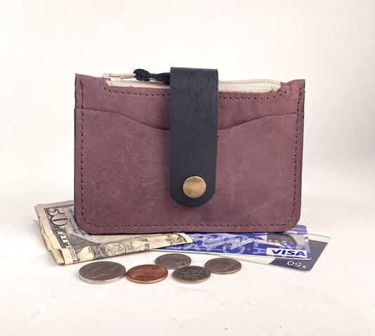 Minimalist wallet with zippered pocket for cards and cash and coins.