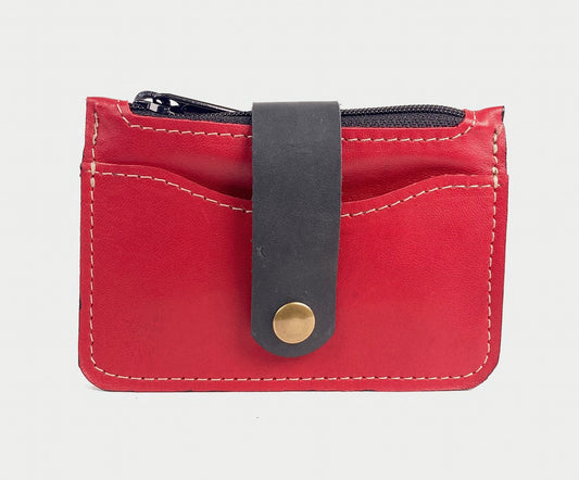 Red leather minimalist wallet with zippered pocket.